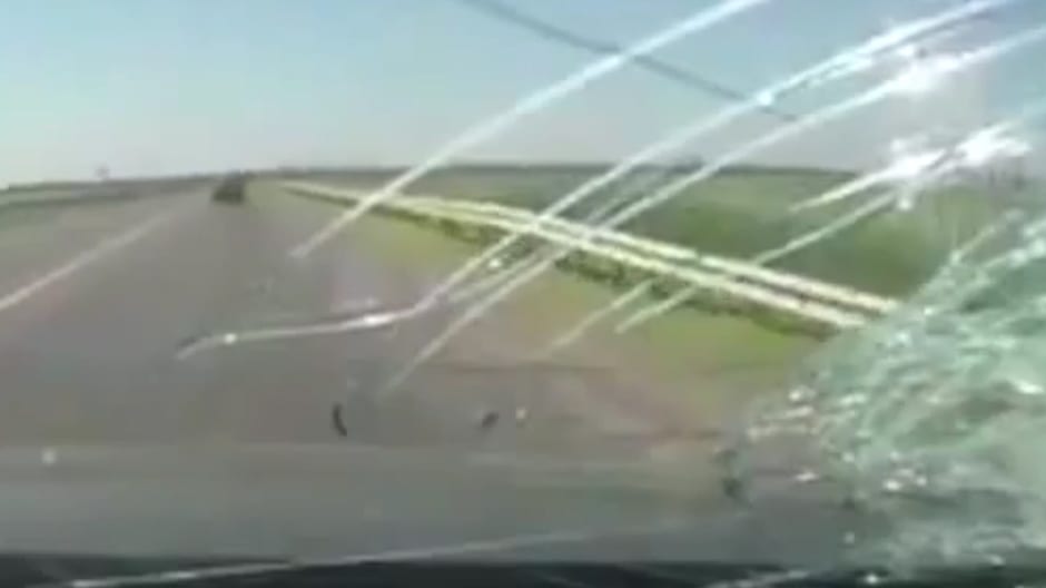 Woman killed by brick through windshield